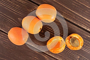 Fresh orange apricot on brown wood