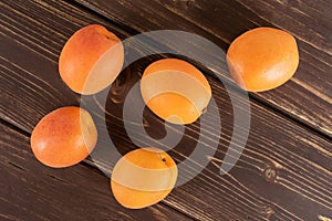 Fresh orange apricot on brown wood