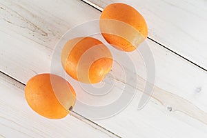 Fresh orange apricot on grey wood