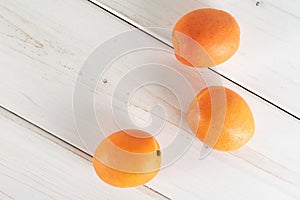 Fresh orange apricot on grey wood