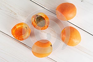 Fresh orange apricot on grey wood