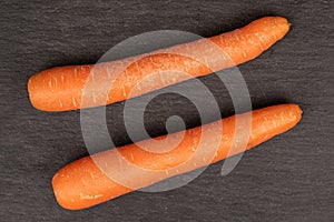 Fresh orange carrot on grey stone