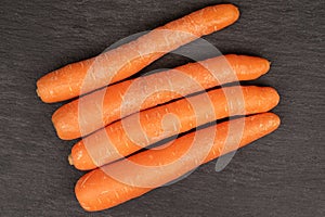Fresh orange carrot on grey stone
