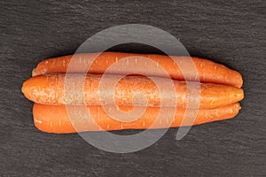 Fresh orange carrot on grey stone