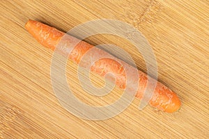 Fresh orange carrot on light wood