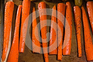 Fresh orange carrots on a baking sheet