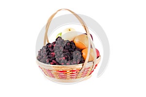 Fresh orange, Chinese pear, green apple and mulberry in bamboo wicker basket on white background fruit health food isolated