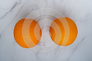 Fresh orange citrus fruit isolated on marble texture background. Juicy and sweet and renowned for its concentration of vitamin C