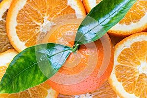 Fresh orange fruit with cut in half slice and green leaf isolated on wood background . Top view. Flat lay. Close up