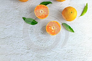 Fresh orange fruit cut in half on a white background