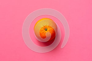 Fresh orange fruit on fuscia background