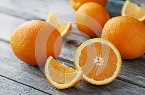 Fresh orange fruit on grey wooden background.