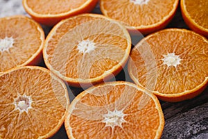 Fresh orange fruit. Halves of citrus background. Cut fresh fruits on wooden table.