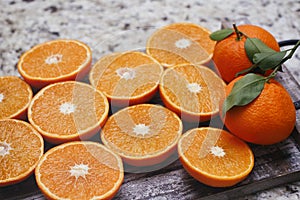 Fresh orange fruit. Halves of citrus background. Cut fresh fruits on wooden table.