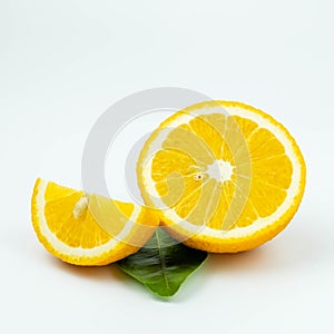 Fresh orange fruit, orange fruit sliced and green leaves on white background