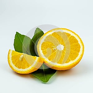 Fresh orange fruit, orange fruit sliced and green leaves on white background