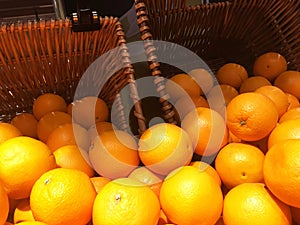 Fresh orange fruit pile on stall in supermarket