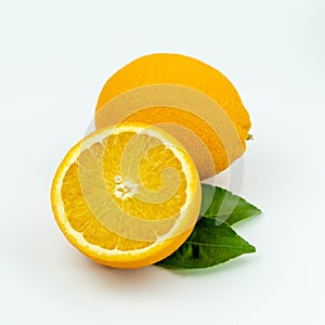 Fresh orange fruit with sliced and green leaves on white background