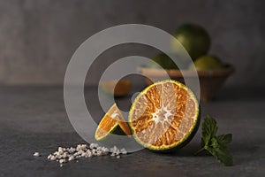 Fresh orange fruits and juice on stone table