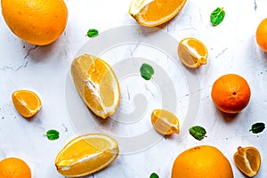 Fresh orange fruits with mint on table background top view patte