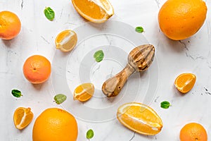 Fresh orange fruits with mint on table background top view pattern