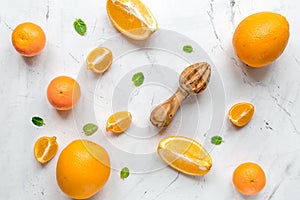 Fresh orange fruits with mint on table background top view pattern