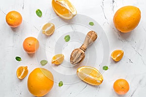Fresh orange fruits with mint on table background top view pattern