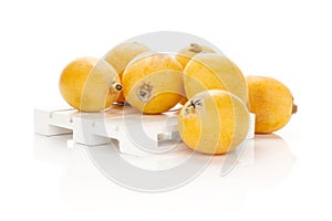 Fresh orange Japanese loquats isolated on white