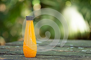 Fresh orange juice in bottles on table.