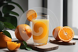 Fresh orange juice in glass cup next to a sliced orange