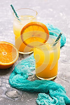 Fresh orange juice in a glass with an orange slice. Summer refreshing drink.