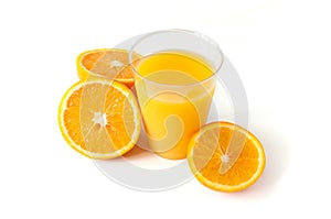 Fresh orange juice in a glass. Round orange slices on a white background. Citrus tropical fruit background. Bright food.