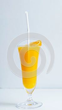 Fresh orange juice in the glass with a tropical fruit slice ready for a drink