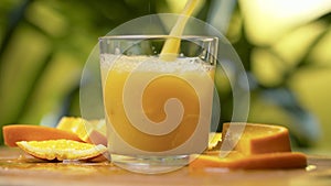 Fresh orange juice pouring into a glass