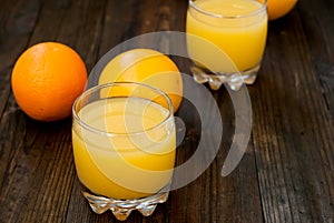 Fresh orange juice on wooden table