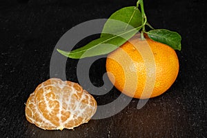 Fresh orange mandarin on grey stone