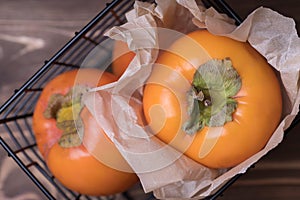 Fresh orange persimmon whole fruit in a basket