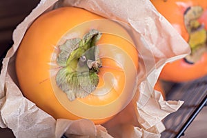 Fresh orange persimmon whole fruit in a basket