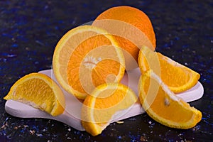 Fresh orange sliced â€‹â€‹in slices on a wooden board.Close-up.