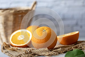 Fresh orange studio packshot with whtie brick background for citrus and summer fruit harvest concept