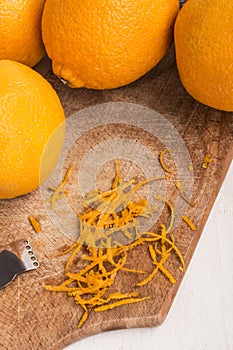 fresh orange and zester to obtaining orange zest on an old wooden board