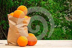 Fresh oranges in eco paper bag, tasty natural products for vegan food and kitchen