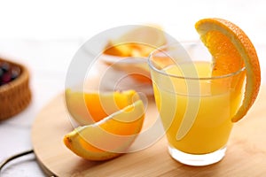 Fresh oranges and a glass of orange juice