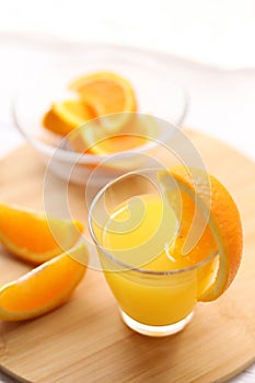 Fresh oranges and a glass of orange juice