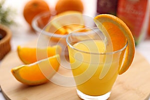 Fresh oranges and a glass of orange juice