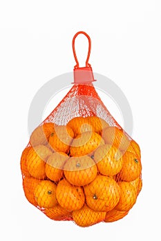 Fresh Oranges in Plastic Mesh Sack isolated on white.