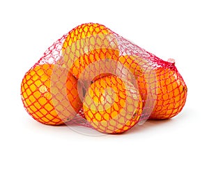 Fresh oranges in plastic mesh sack