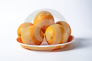 Fresh oranges on a plate isolated on a white background