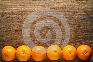 Fresh oranges on wooden background.