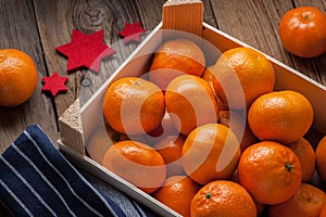 Fresh oranges in wooden box